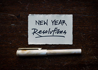 Pen and Paper with New Year's Resolution.