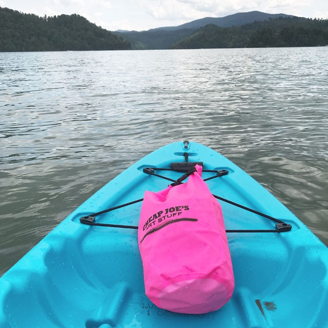 Waterproof Dry Bag full of Art Stuff clipped to a Kayak